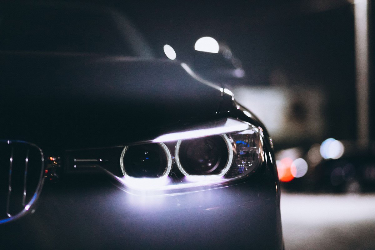 LED headlights glowing at night — only ECE-approved LEDr bulbs with the manufacturer's sticker pass the MOT